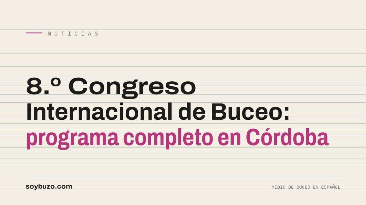 Sala de conferencias con público de buceadores y una pantalla que muestra un perfil de inmersión